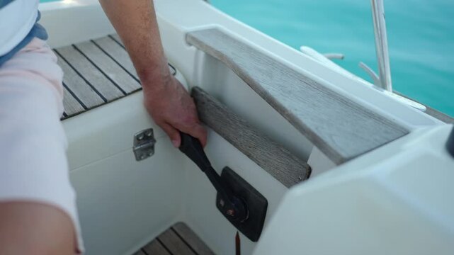 Captain shifting throttle lever on yacht