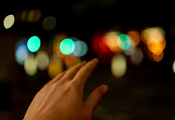 Fototapeta premium abstract scene of hand touching Christmas lights
