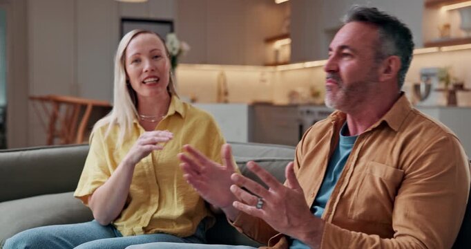 Argument, fighting and shouting with couple on sofa in home for conflict or disagreement. Mature man, angry woman and stress with yelling in apartment for blame, frustration or marriage mistake