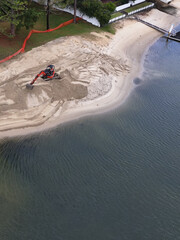 Fototapeta premium Aerial View of Excavator Moving Sand on Gold Coast Canal Beach