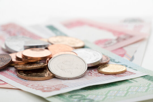 Foreign coins and banknotes on white background