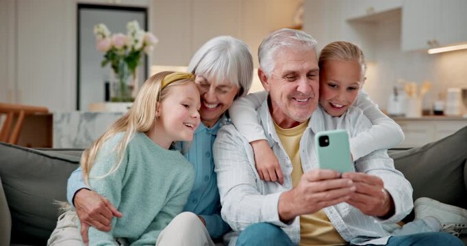 Grandparents, children and selfie in home with funny face, hug or family bonding for social media post. Happy, grandma and grandpa in living room with grandkids, embrace or tongue out for photography