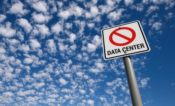 No data center sign under a blue sky filled with clouds shows a warning for a specific area