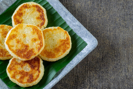 Wingko Babat, authentic Javanese sweet snack made of glutinous rice flour and grated coconut. served on a plate lined with a green banana leaf
