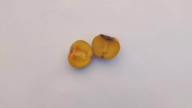 A fresh persimmon or Diospyros kaki on a white background