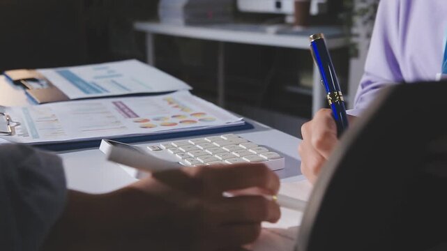 Business accounting concept, Business man using calculator with computer laptop, budget and loan paper in office.