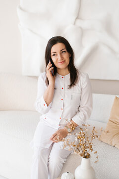 Smiling Female Healthcare Specialist Talking on Phone
