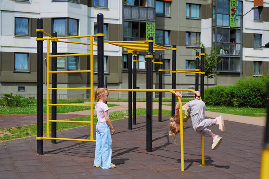 Young girls enjoying active play on a modern outdoor playground