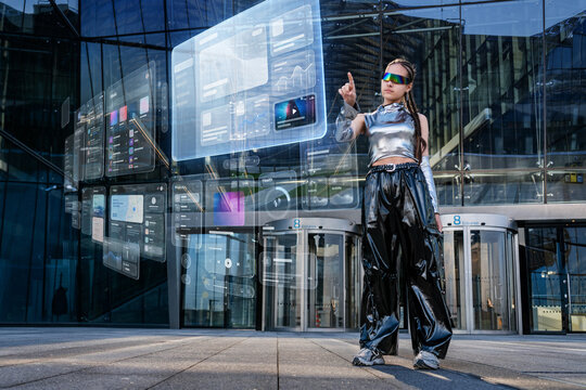 Young woman interacts with holographic data screens