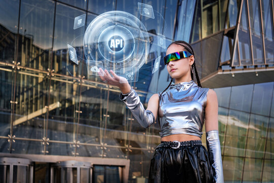 Young woman interacts with futuristic API hologram