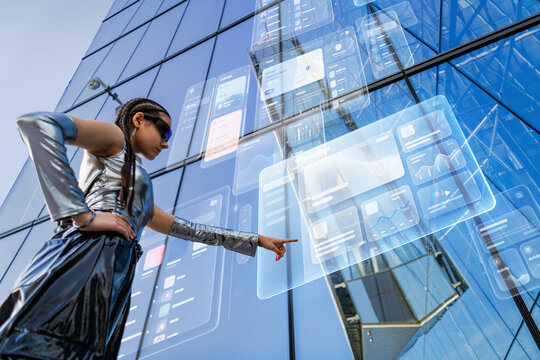 Woman in futuristic clothing using holographic interface