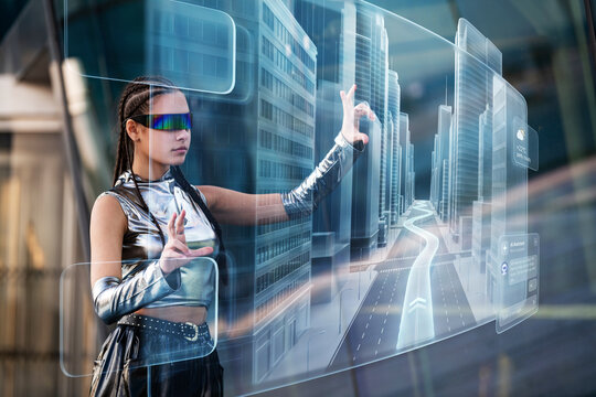 Young woman in futuristic clothes interacts with holographic city map