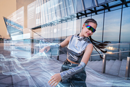 Young woman in futuristic clothes dances with AR interface