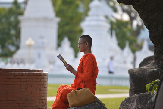 Novice monk on during sunset,read book