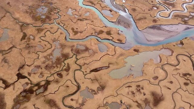 Aerial view of striking abstract tidal river patterns in East Iceland landscape