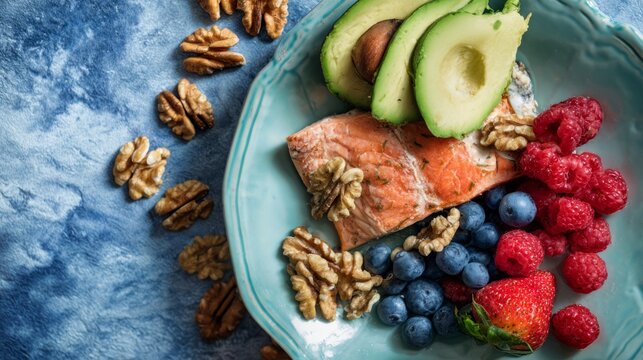 Flat lay of grilled salmon, walnuts, berries, and avocado, clean eating nutrition concept.
