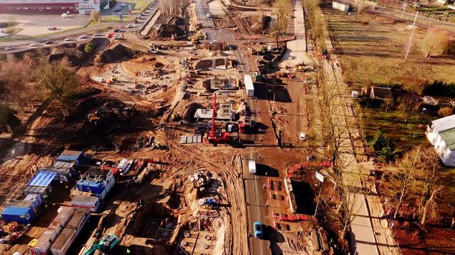 Large urban bridge project advances with cranes traffic and earthworks underway
