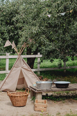 Children's teepee play tent in a rustic backyard garden © eugenivy