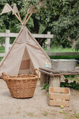 Children's teepee play tent in a rustic backyard garden © eugenivy