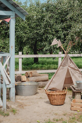 Children's teepee play tent in a rustic backyard garden © eugenivy