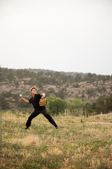 Boy throwing baseball in the mountains © Cavan