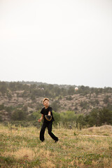 Boy catching baseball in field in mountains © Cavan