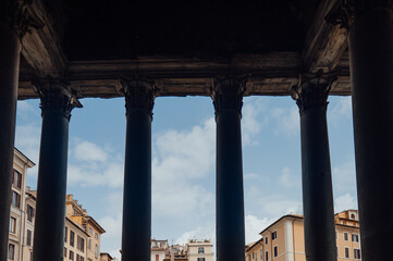 Fototapeta premium A view of Rome through the Pantheon portico columns