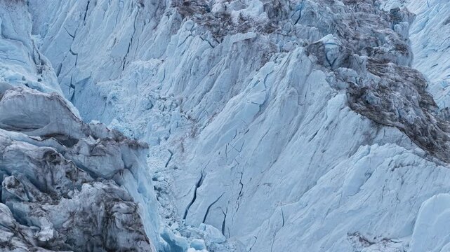 Glacial ice avalanche thundering down a crevasse