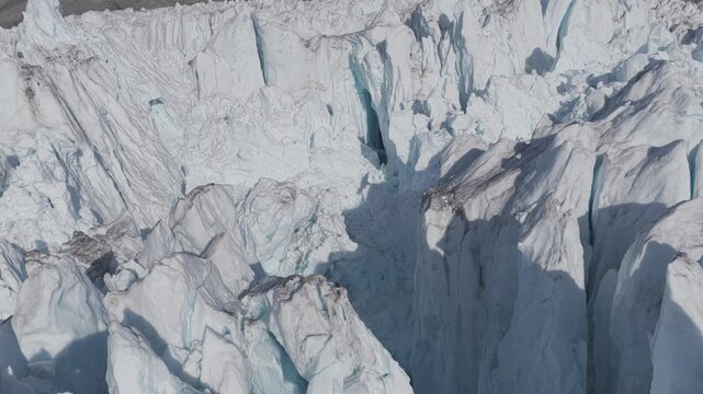 An aerial view of a vast and fractured glacier