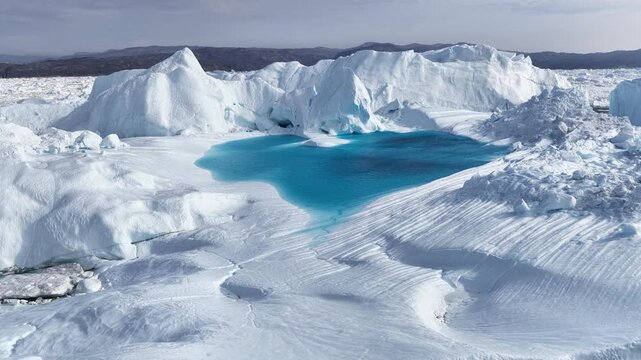 Vivid blue meltwater pool on a massive glacier