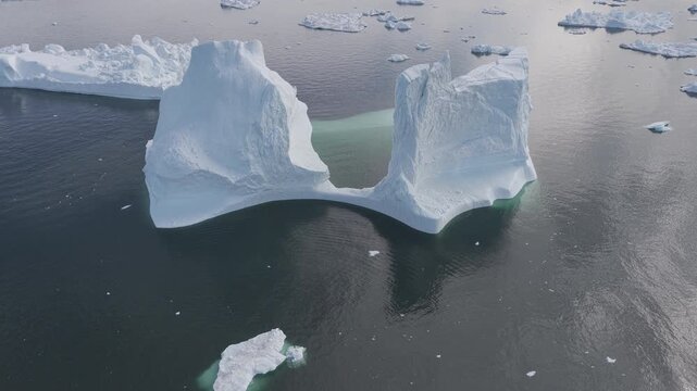 Majestic iceberg arch in Ilulissat Icefjord Greenland