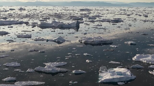 Melting icebergs floating on a calm arctic sea