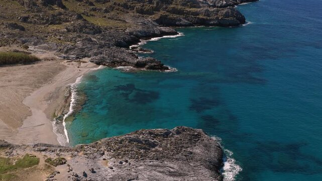 Mediterranean clear waters on Crete island on a sunny day of summer, drone aerial video
