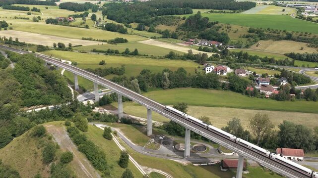 Modern high speed train traveling on a bridge in Germany, drone aerial video
