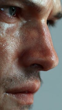 A hyper realistic close up of a man's face highlights pores, stubble, and natural imperfections. The intense gaze and detailed skin create a powerful, authentic visual impact for creative projects