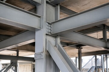 Fototapeta premium underpinning. Architectural steel framework supporting concrete structure in natural daylight. real-estate listings.