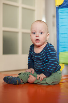 Little wonder's gaze upon a vibrant world, enjoying a peaceful moment in a cozy play space