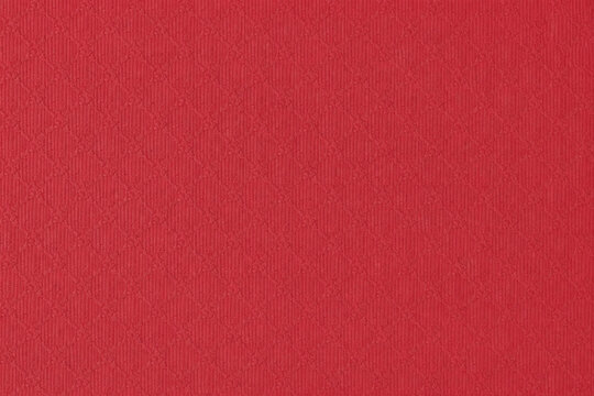 Red paper texture with subtle square grid pattern and fine matte finish. Structured decorative surface ideal for stationery, packaging, backgrounds, and modern graphic design.