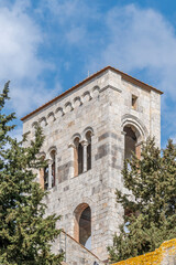 Fototapeta premium A detail of the bell tower of the ancient Abbey of San Savino, located in Montione, in the municipality of Cascina, province of Pisa, Italy