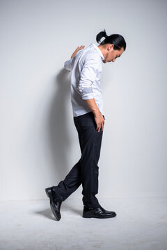 Asian man wearing shirt and trousers poses for photos
