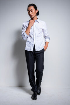 Asian man wearing shirt and trousers poses for photos