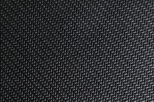 Black rubber texture with raised interlocking pattern and matte finish. Durable anti slip surface ideal for flooring, industrial mats, gym areas, and functional design backgrounds.