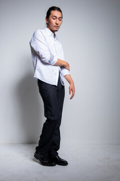 Asian man wearing shirt and trousers poses for photos