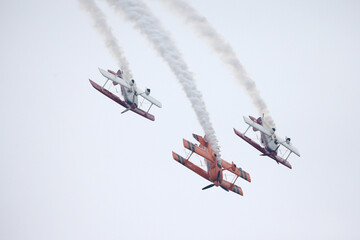 Three Biplanes in Formation Flight with Smoke Trails © DoMinh