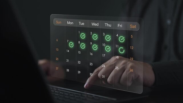 Business team member organizing a monthly schedule and tracking daily tasks on a digital calendar interface. Concept of time management, routine workflow planning, and project deadline control.