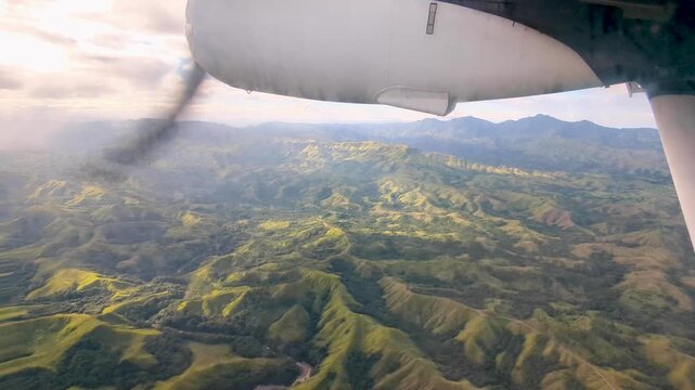 Flying over rugged Fijian landscape of Viti Levu tropical island in small propeller airplane in Fiji, South Pacific