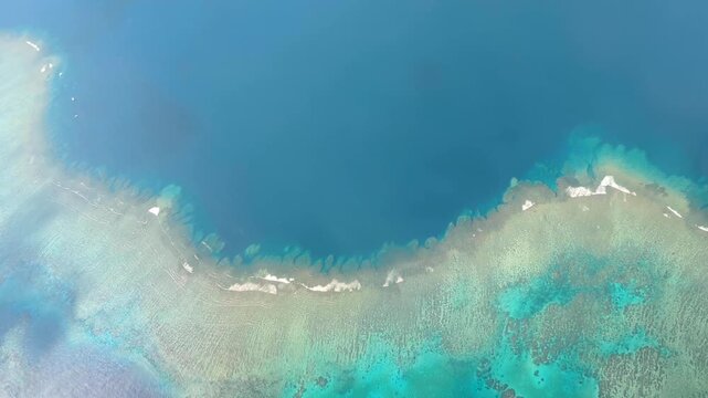 Airplane window view flying over ocean coral reef environment in outer tropical islands of Fiji in South Pacific