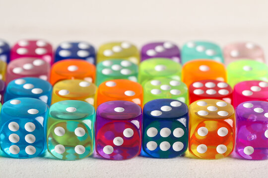 Colorful game dices on white wooden background