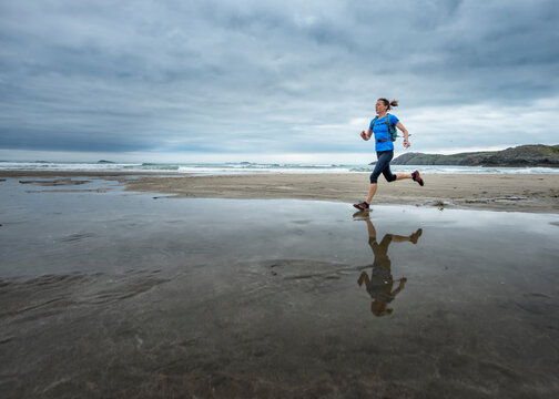 UK, Pembrokeshire, Whitesands bay, Mature woman running the coast path