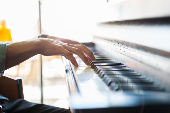 Close-up of man playing piano